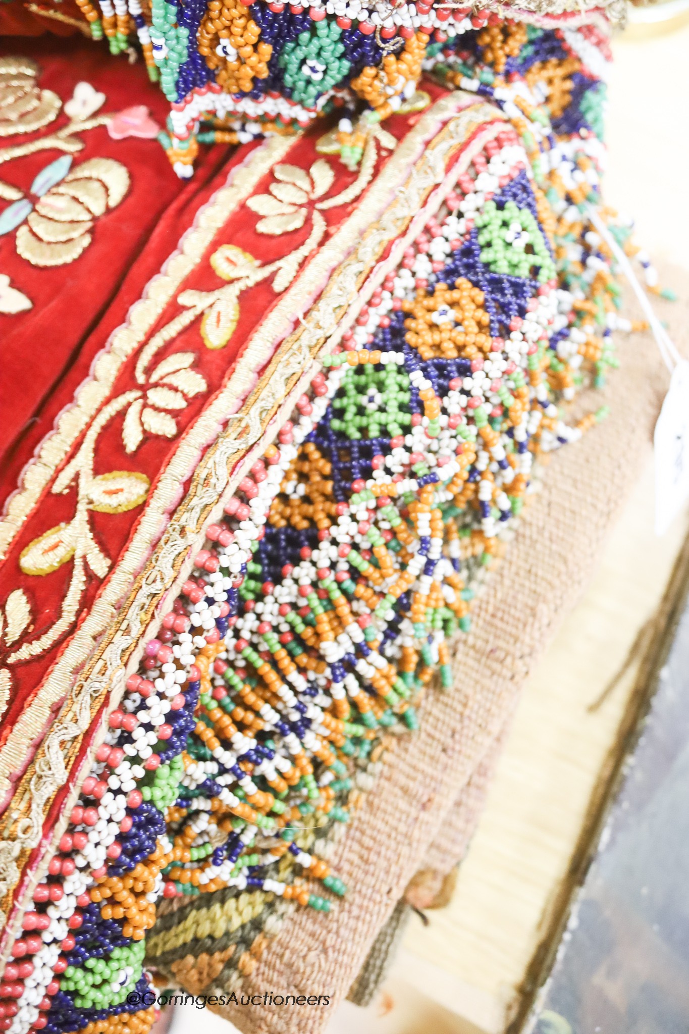 Three Indonesian bullion panels, a red velvet gold embroidered hanging, an Indian mirrored panel, etc.